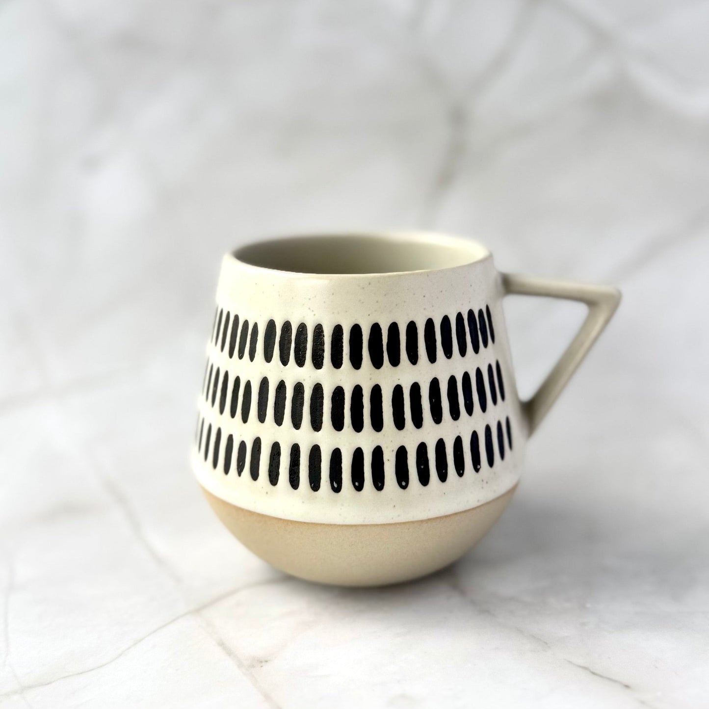 warm beige and soft white with natural brown undertones ceramic mug with brown pattern on a white background